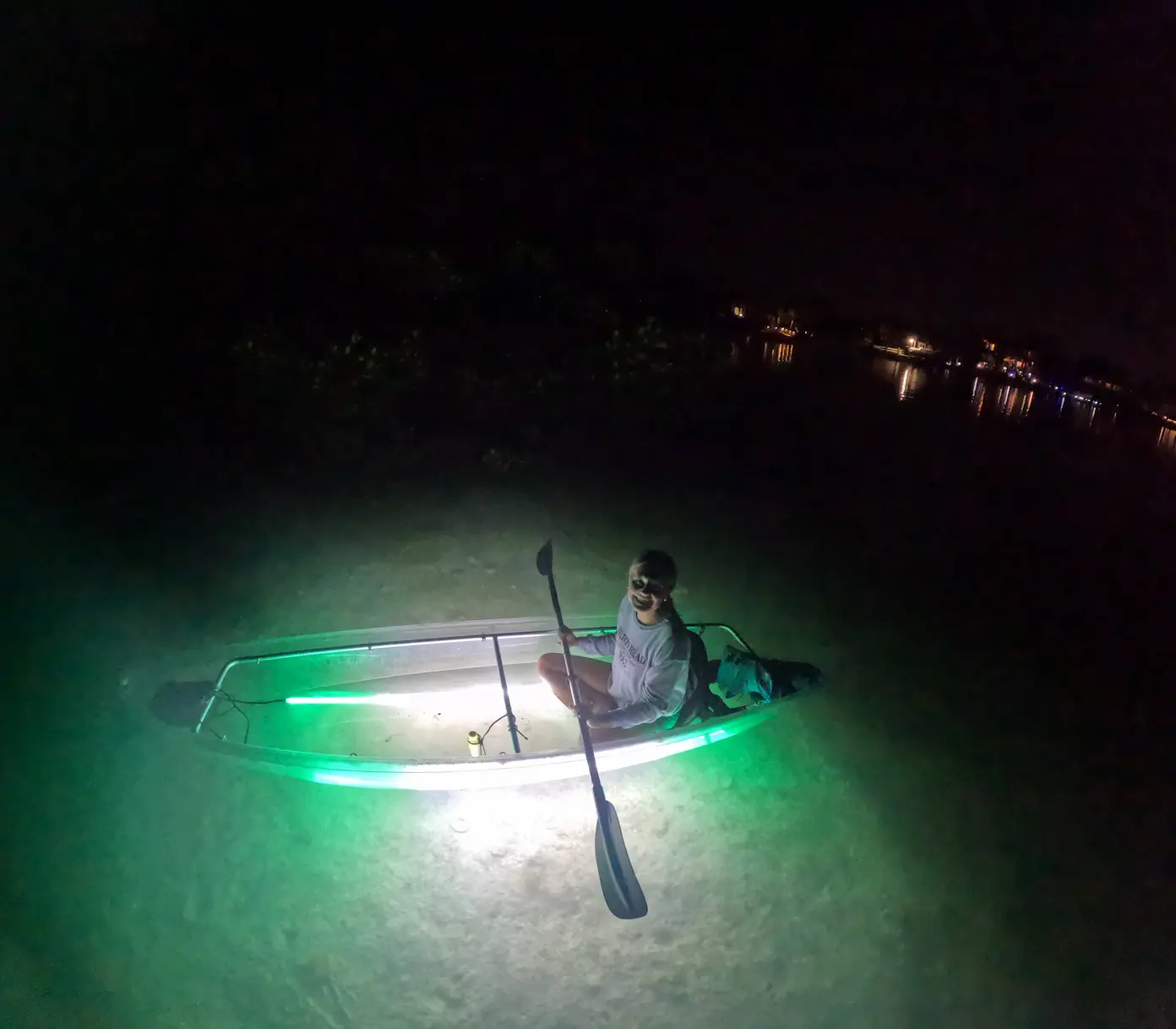 Clear kayak glowing in dark water Sarasota night tour