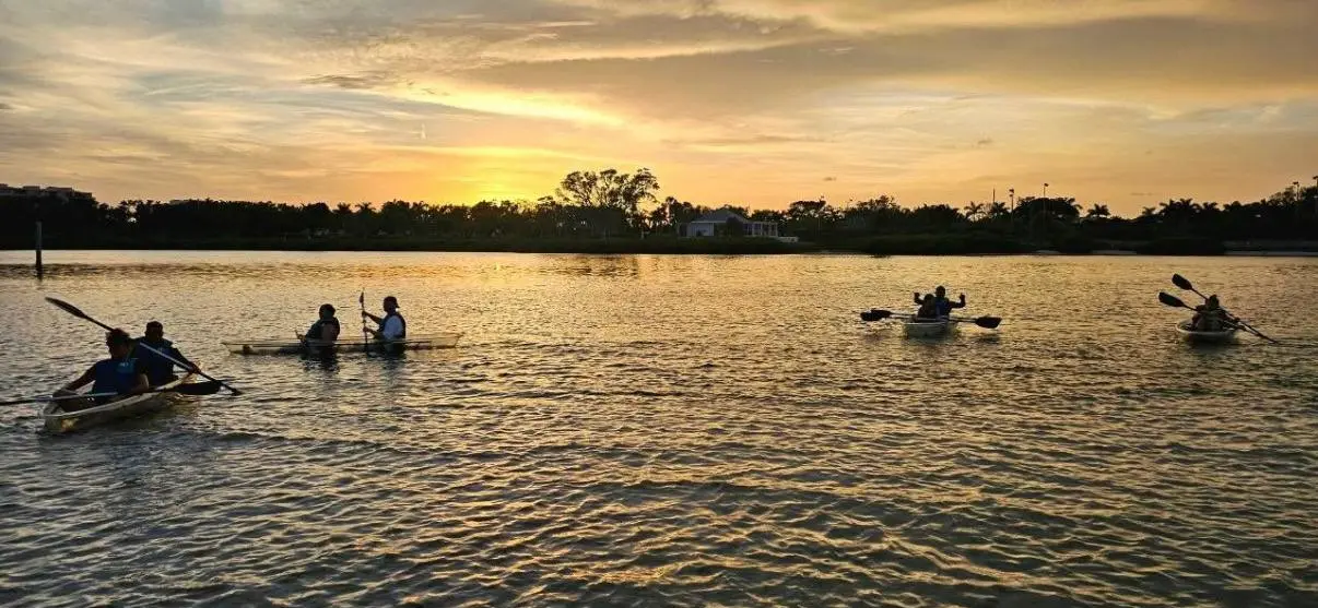 Golden hour sunset clear kayak tour on the calm lagoon at Longboat Key Little Beach