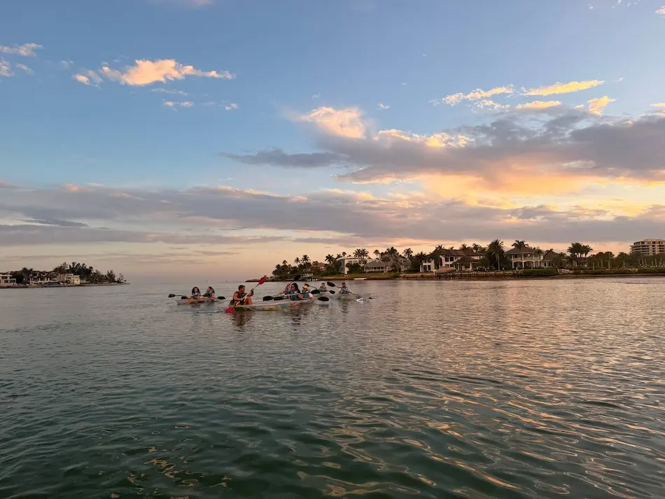 Clear kayak on glassy lagoon water at sunset near Longboat Key Little Beach